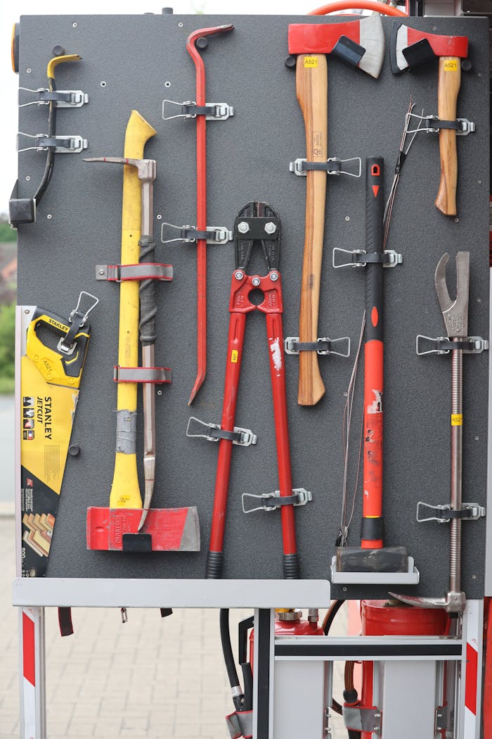 Collection of firefighter tools neatly arranged on a board for easy access.
